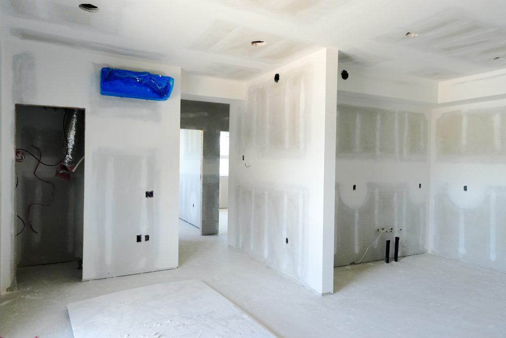 M&M Painting Contractors drywall work and paint prep in a new apartment building.