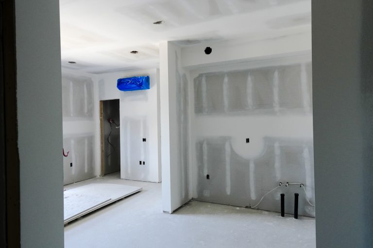 M&M Painting Contractors drywall work and paint prep in a new apartment building.
